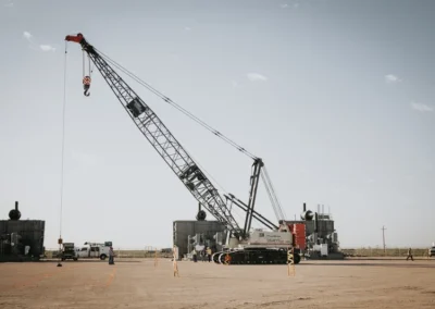 Construction site with crane and equipment under a cloudy sky,